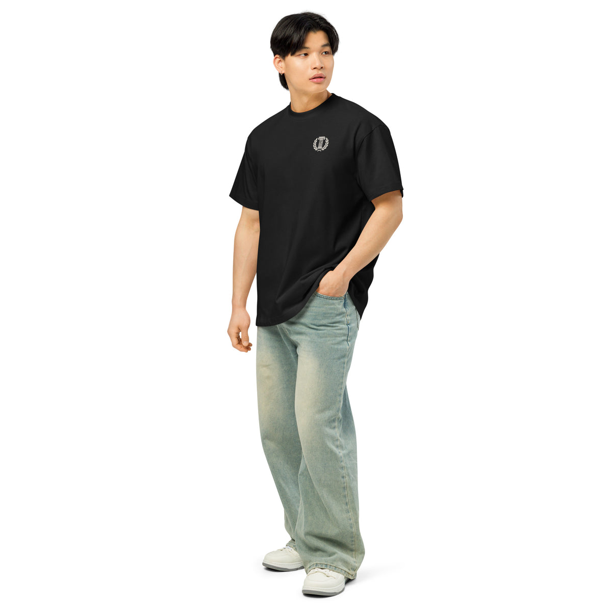 Person wearing a black t-shirt with a red logo and light blue jeans on a white background